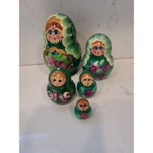A set of 5  nesting dolls made of wood, hand painted